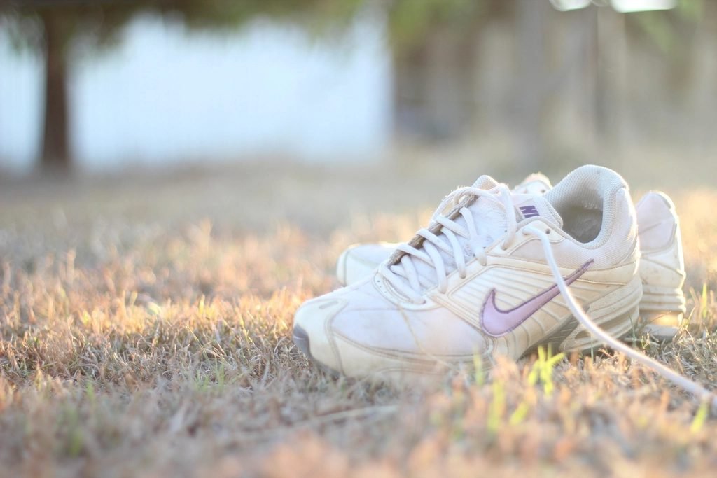 Vintage Nike sneakers with pink swoosh on grass