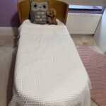 Beautiful Ubabub Pod Cot 2-1 convertible Bed with Junior Bed Conversion Kit in natural wood.