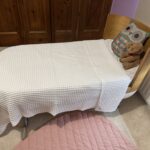 Beautiful Ubabub Pod Cot 2-1 convertible Bed with Junior Bed Conversion Kit in natural wood.